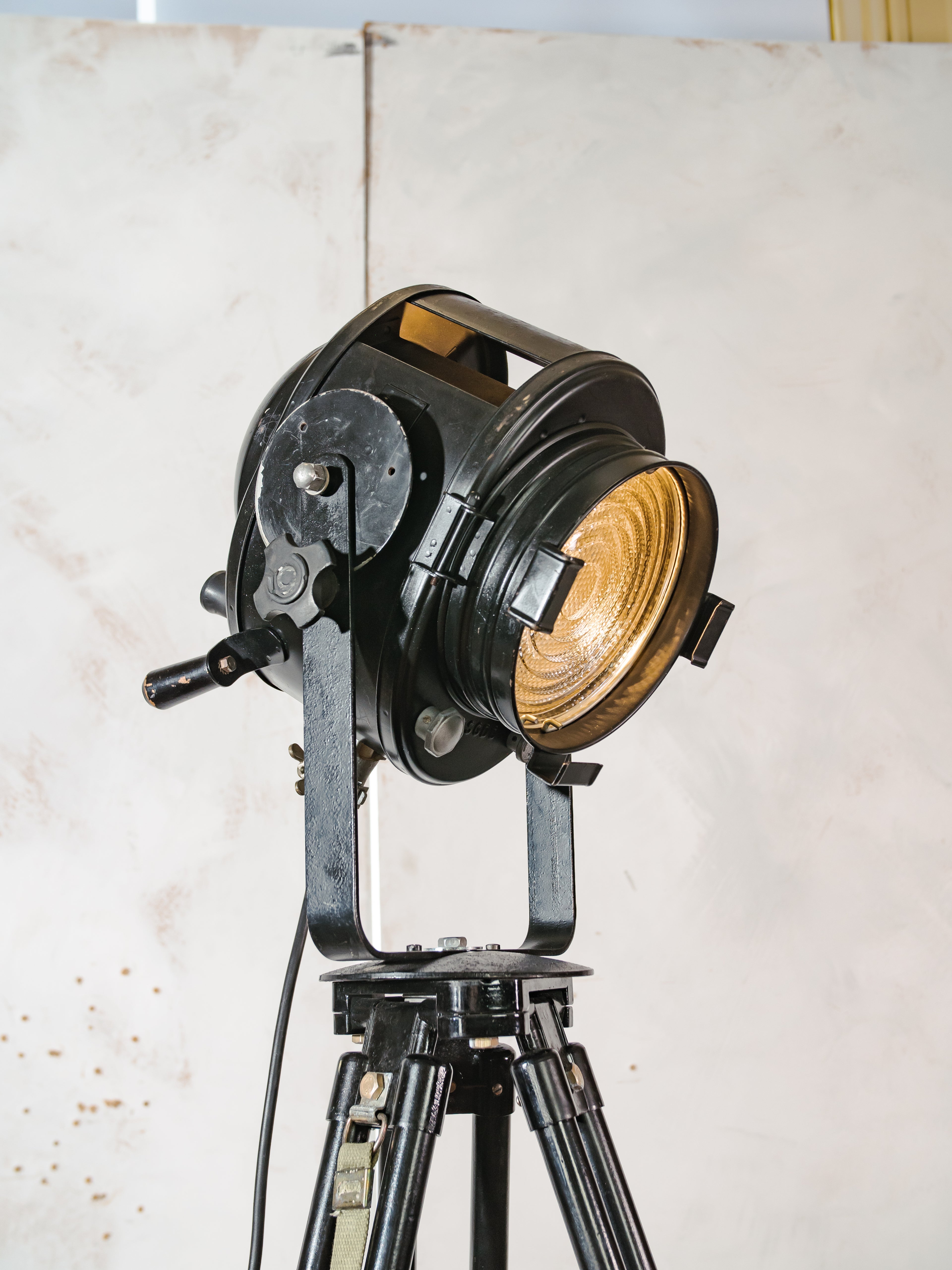 1950s Black A.E. Cremer Paris Industrial Film Spotlight Floor lamp, Mounted on Wooden Surveying Tripod, French Antique Spotlight
