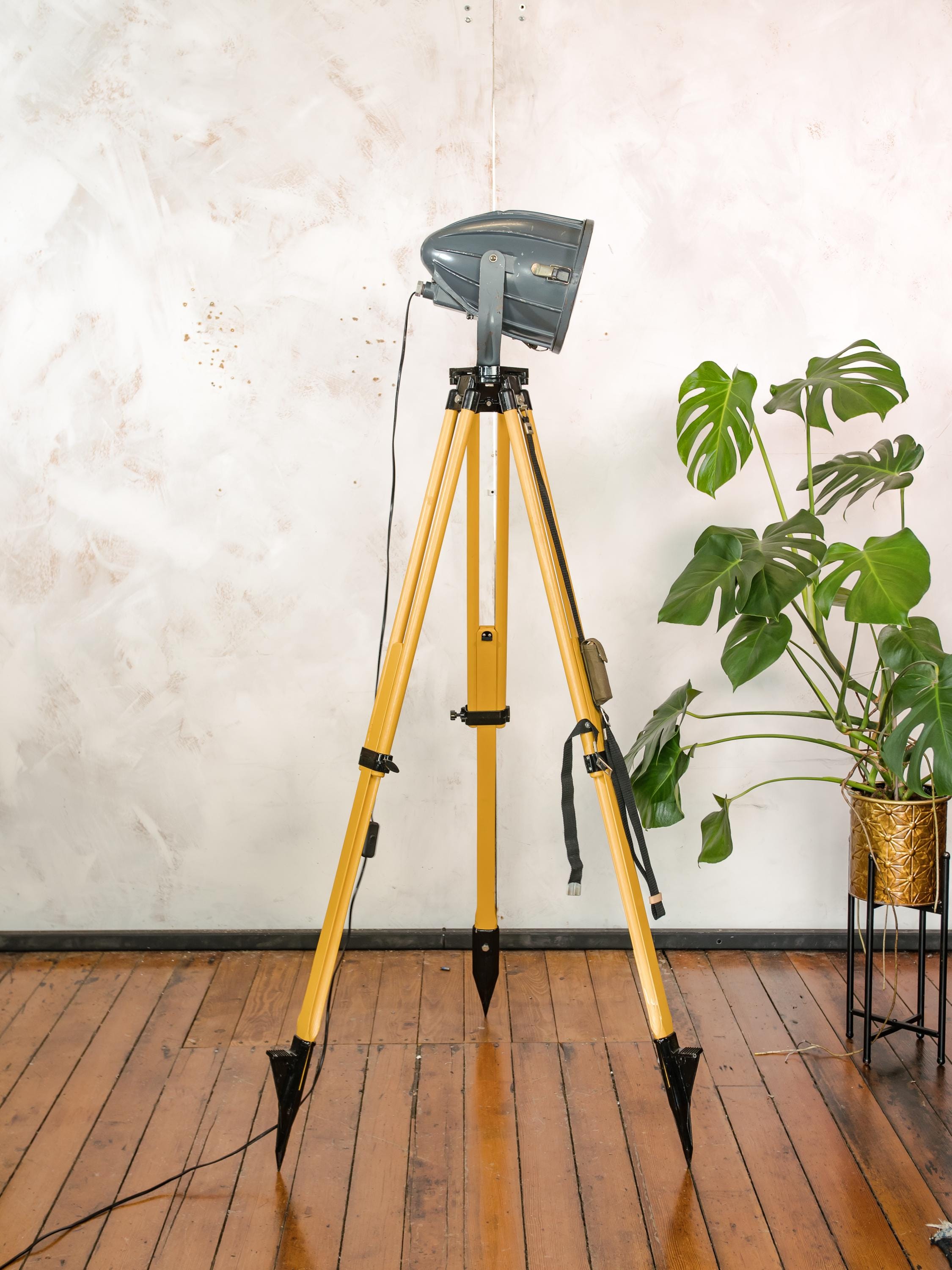 Donkergrijze Sovjet-spot uit de jaren 70 op een landmeetkundige driepoot, industriële vloerlamp in raketvorm, vintage reflectorprojectorlamp